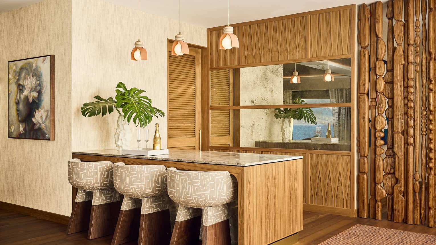Designer wooden bar with three chairs in luxury resort suite