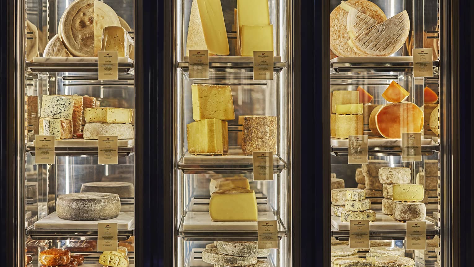 Three glass-walled cheese displays