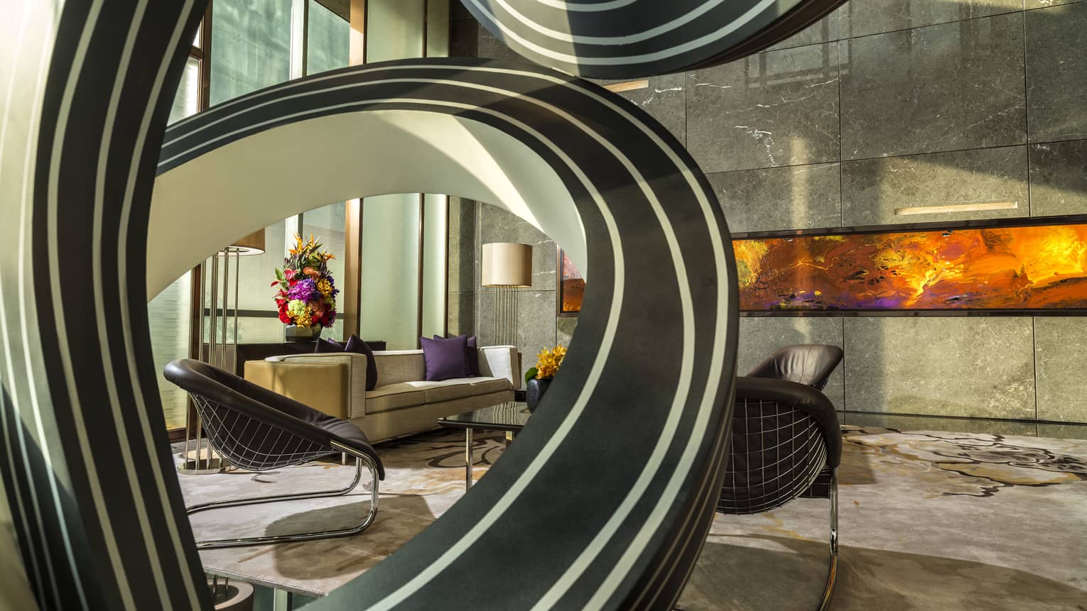 A fluid, circular sculpture accentuates the lower lobby in Shenzhen
