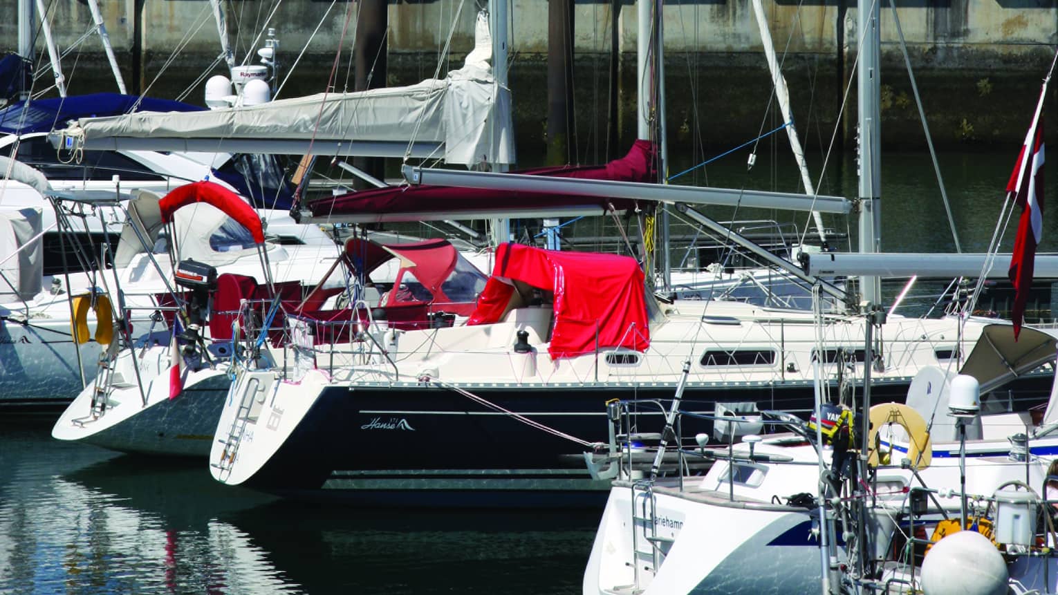 Boats in harbour by small lighthouse