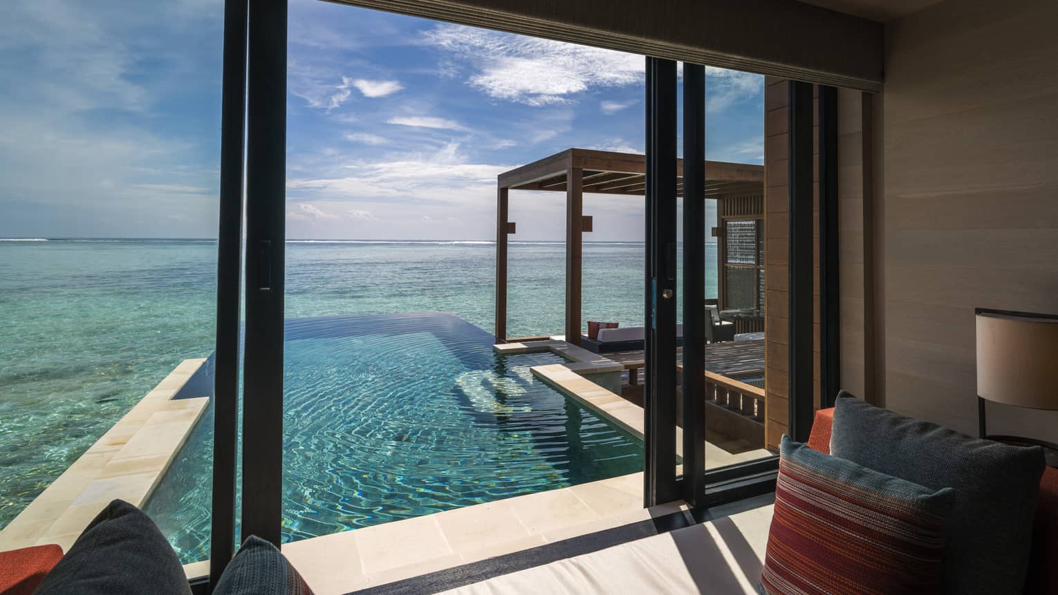 A view from inside the sunrise water villa with pool