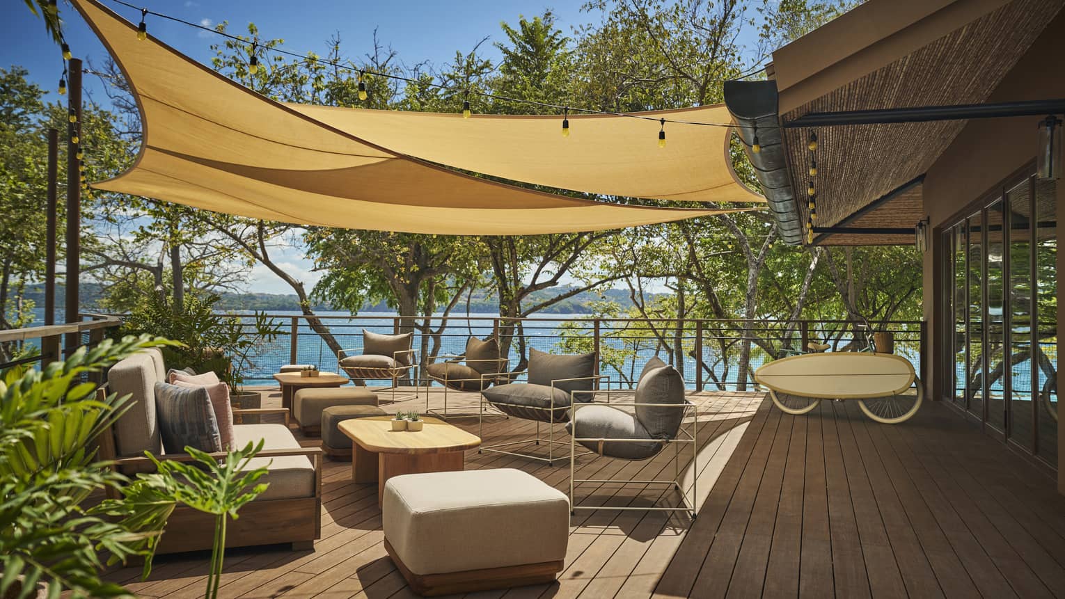 Outdoor patio deck with tan armchairs covered by tarp