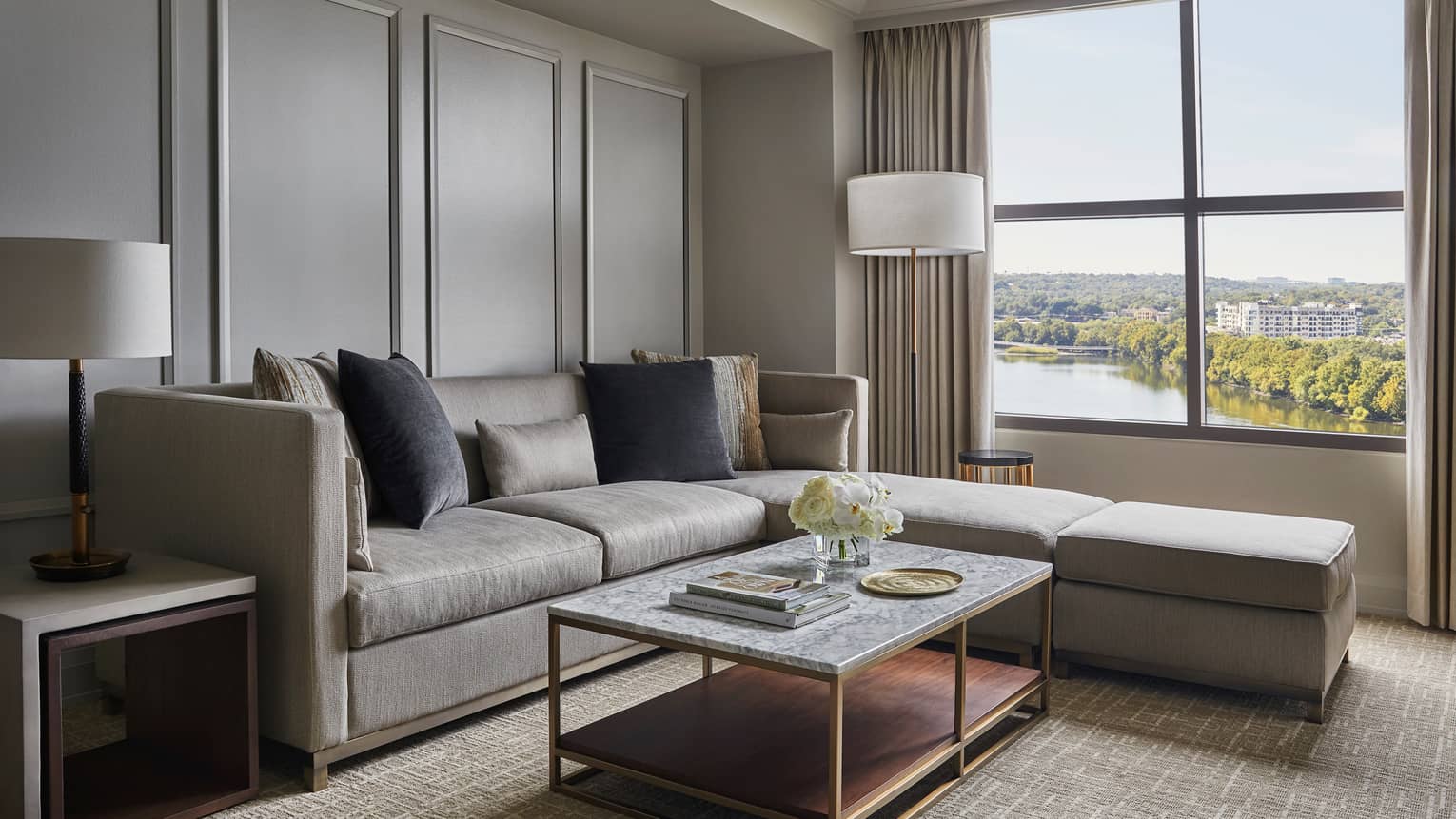 Lake View Suite grey sectional sofa, cushions by floor lamp, large window