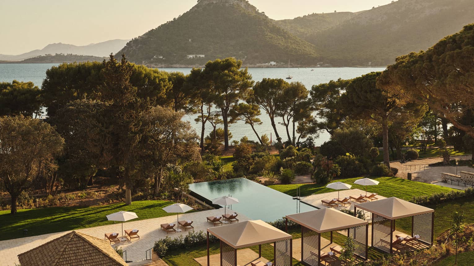 View of pool and ocean/mountain in background