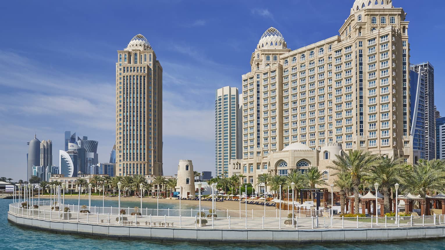 Four Seasons Doha hotel high rise building exterior, beach and palm trees
