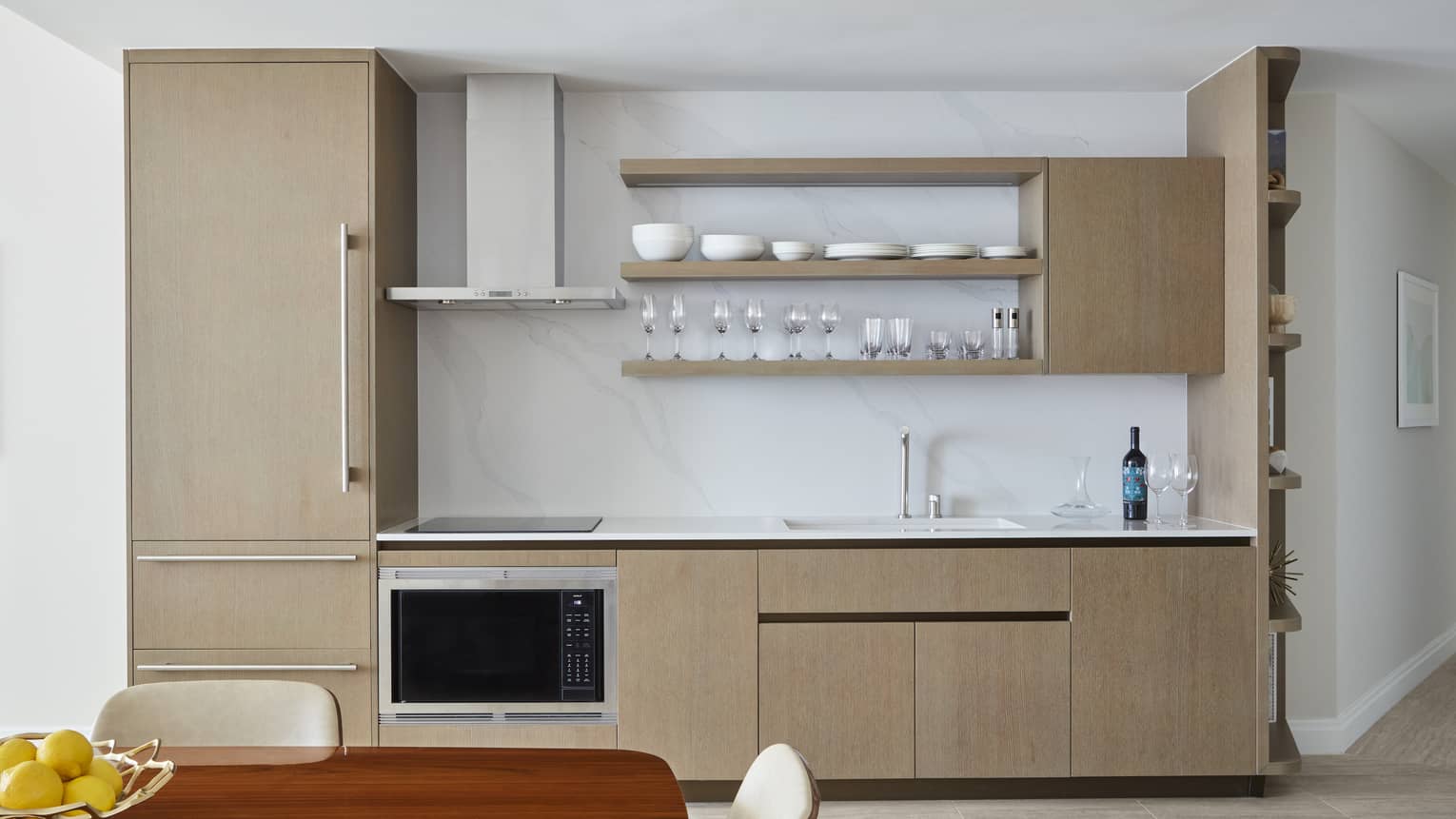 Kitchen with fridge, ocean, sink and exposed shelving