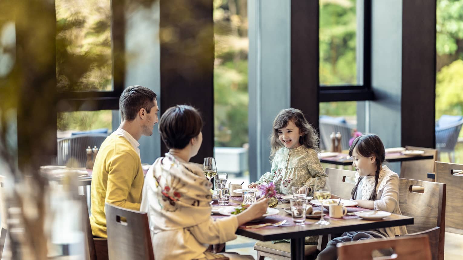 Parents and two young daughters share a meal at Brasserie