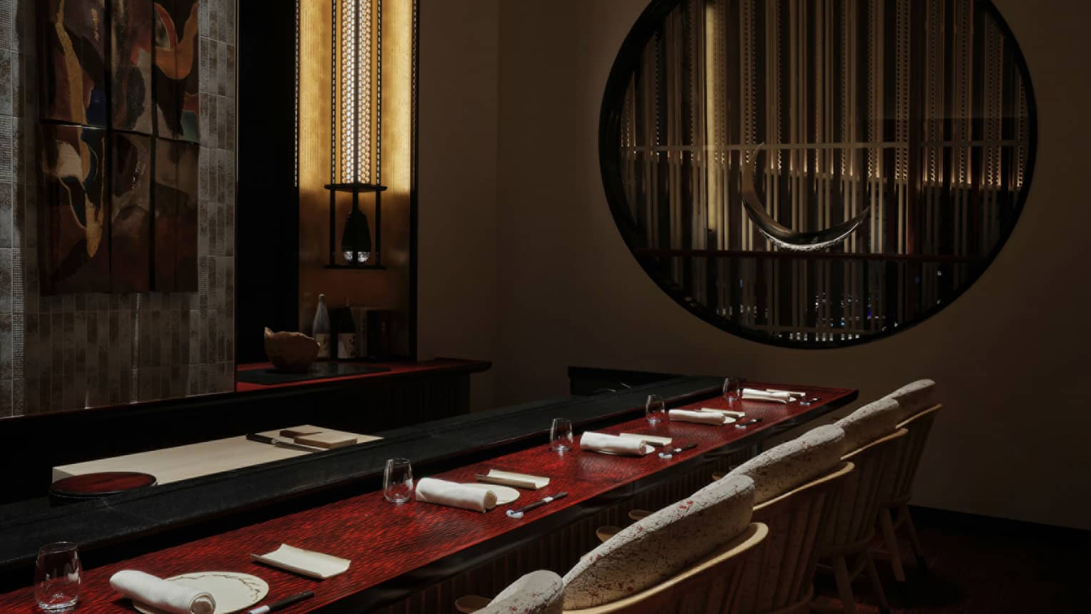 Elegant sushi counter at Sushi L’Abysse Osaka Yannick Alléno, featuring refined decor and ambient lighting.