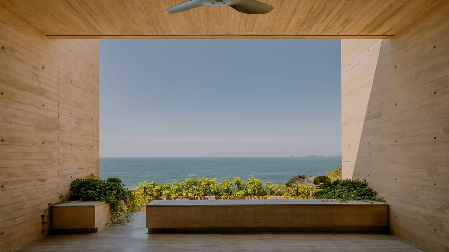 Covered modern terrace looking out to the ocean