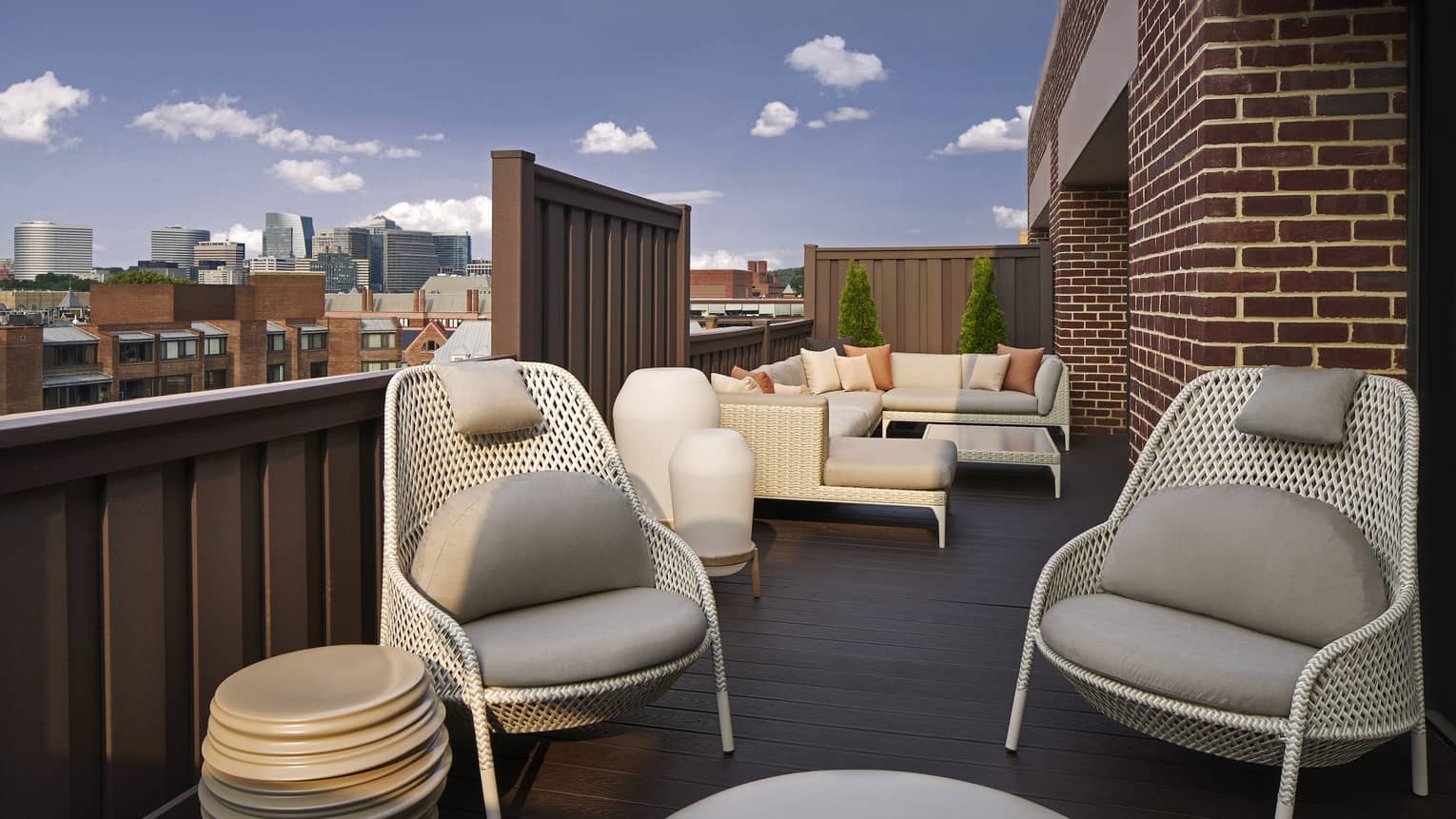 A large, outdoor terrace with cozy chairs and couches