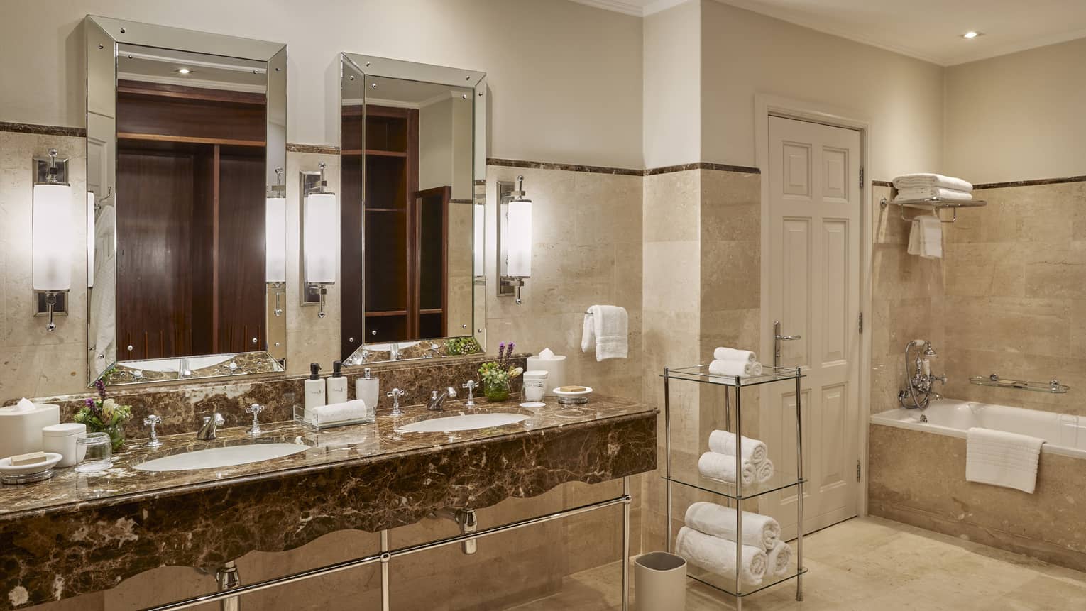 Luxury hotel suite bathroom with double vanity and tub at Four Seasons Hotel Johannesburg