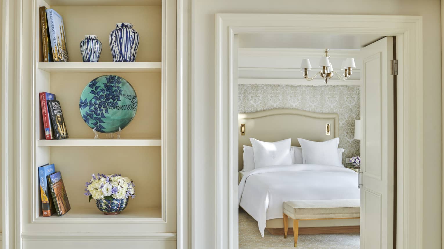 Premium Executive Suite with doorway to bedroom, built-in shelves with colourful decorative items and books