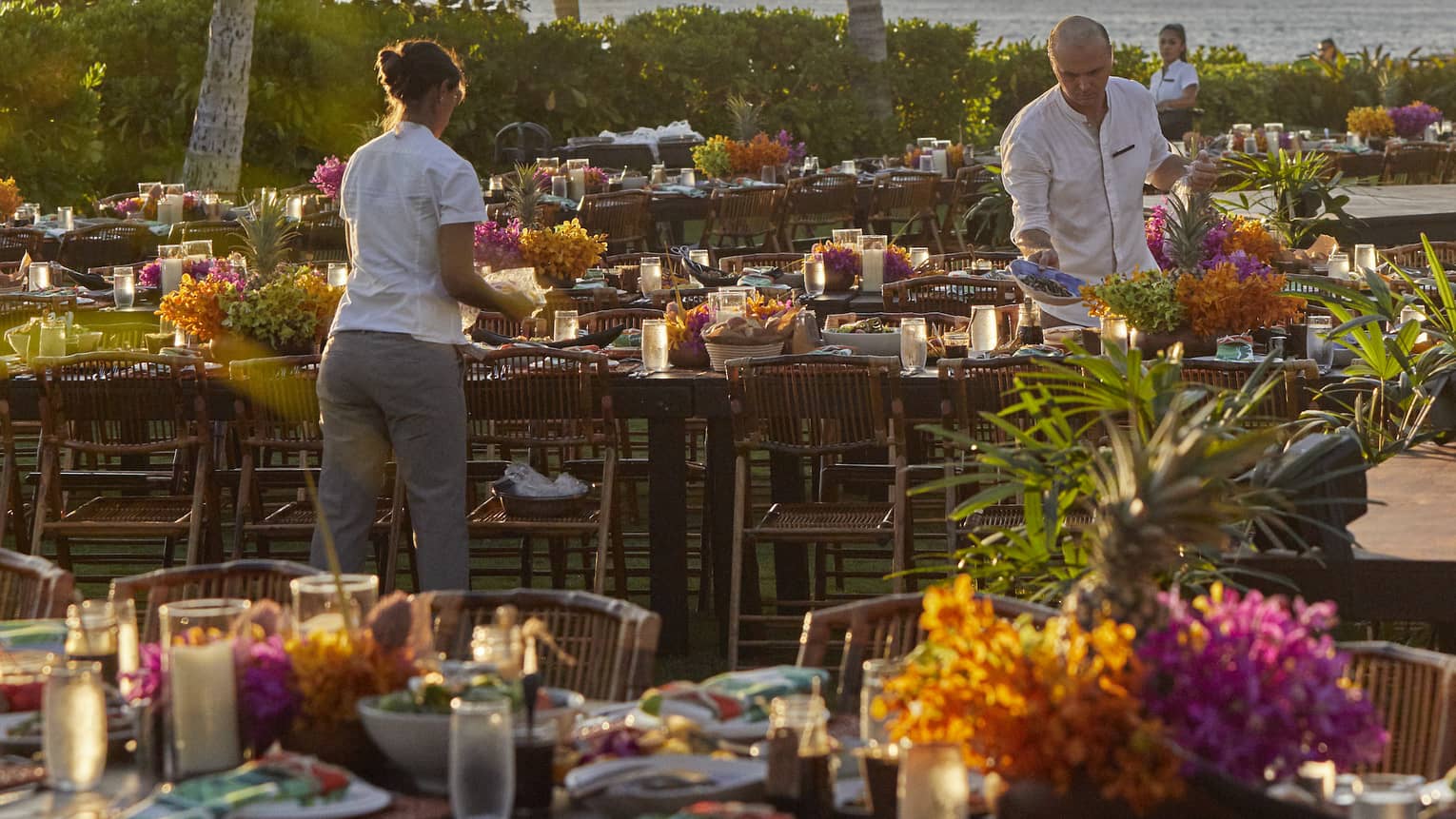 Four Seasons staff setting tables outside of Four Seasons Hawaii, Oahu at Ko Olinaat a Luau Dinner