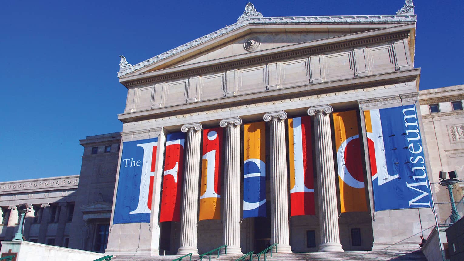 Tall white pillars on exterior of the Field Museum of Natural History, against blue sky