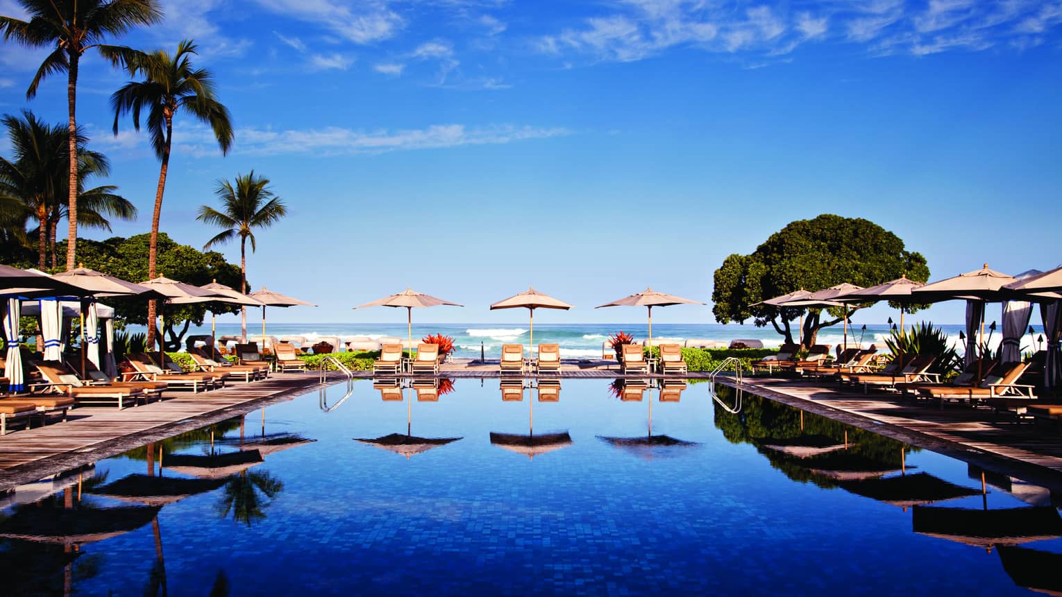 Tropical resort pool with cabanas