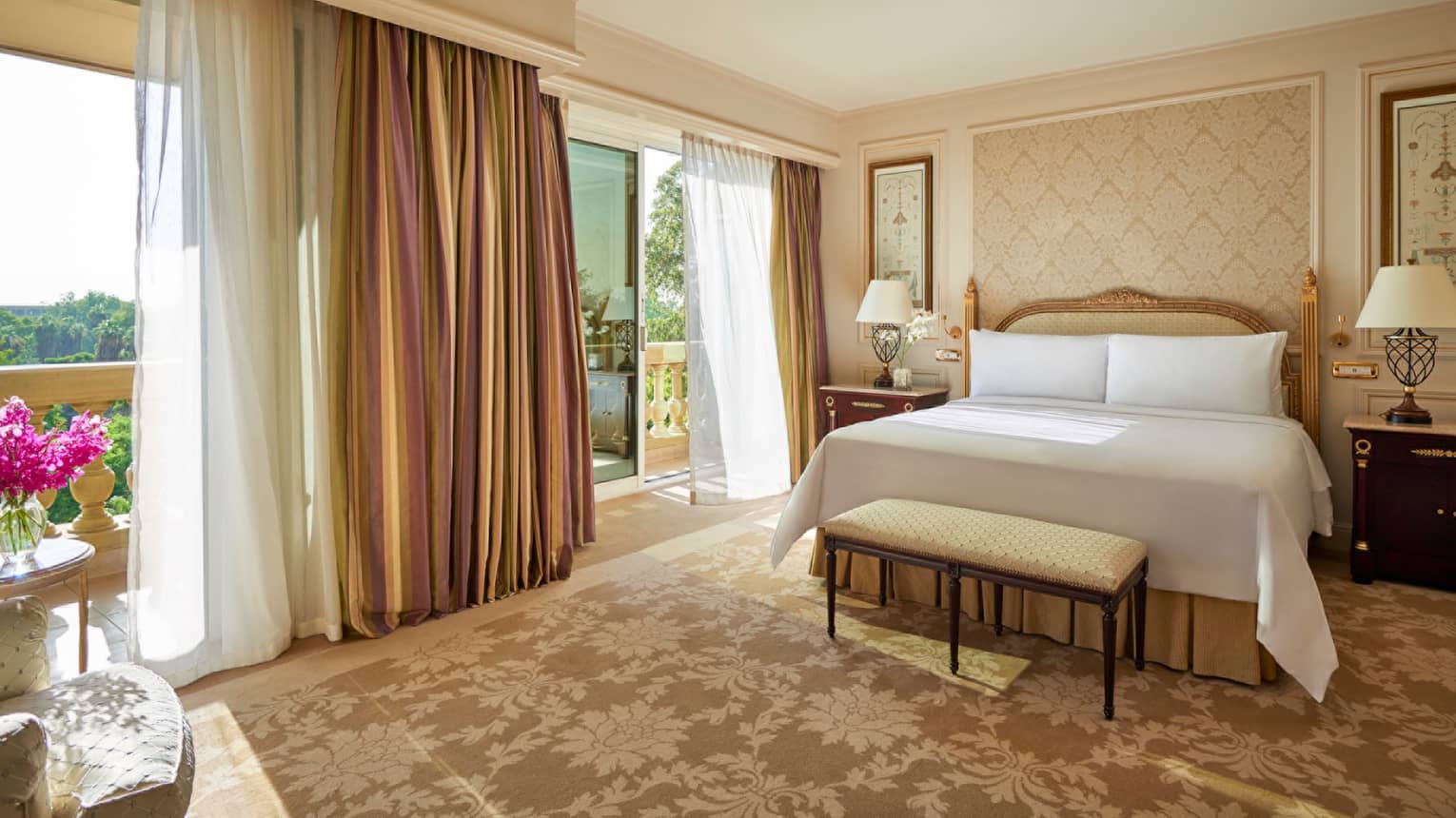 Premium Suite bed, bench near open balcony doors with long curtains