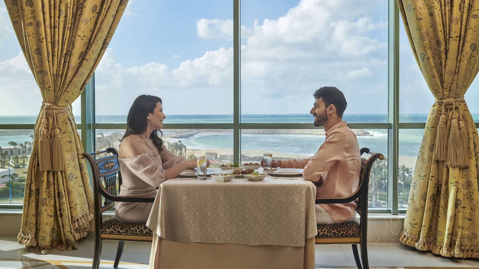Couple enjoys a meal at Byblos Restaurant with views of the Mediterranean Sea