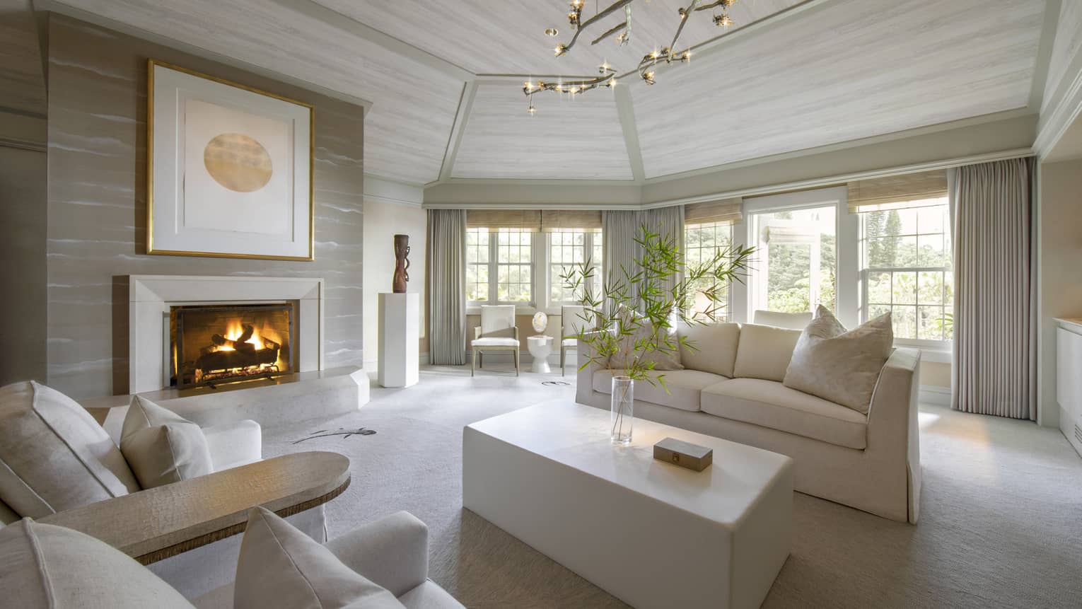 Guest suite living room with white couch and fireplace