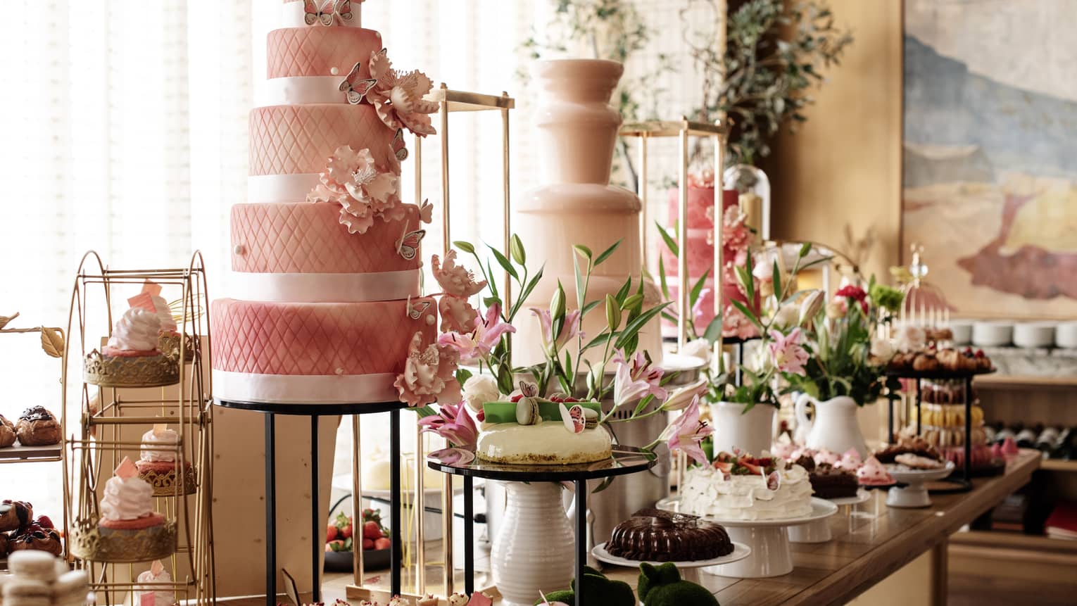 A buffet with cakes, cupcakes and desserts
