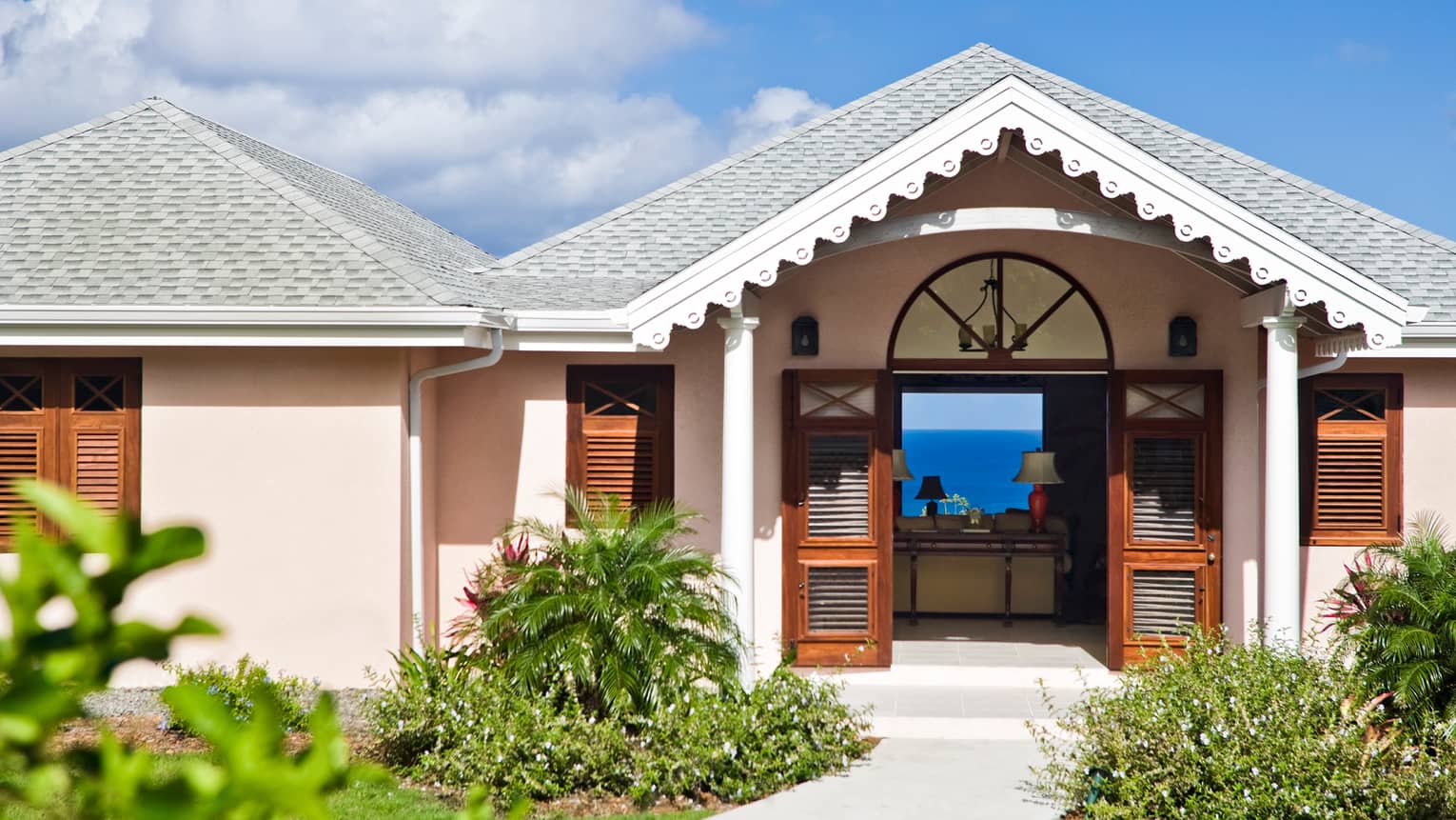 Sunset Hill Residence Villa exterior, pink bungalow with white trim