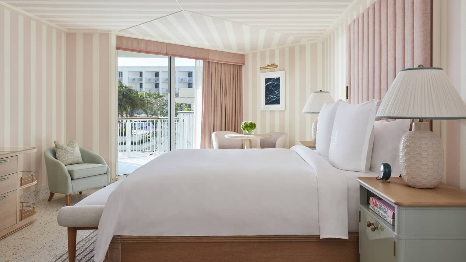 Ocean View Cabana Terrace Room hotel bed, lamp against pink and white walls