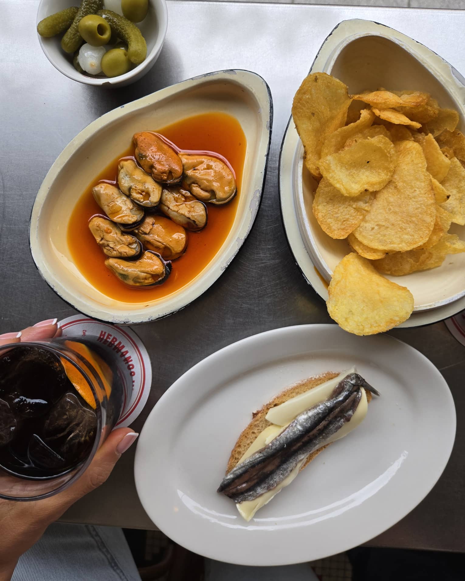 Seafood dish with chips on the side and a drinking glass