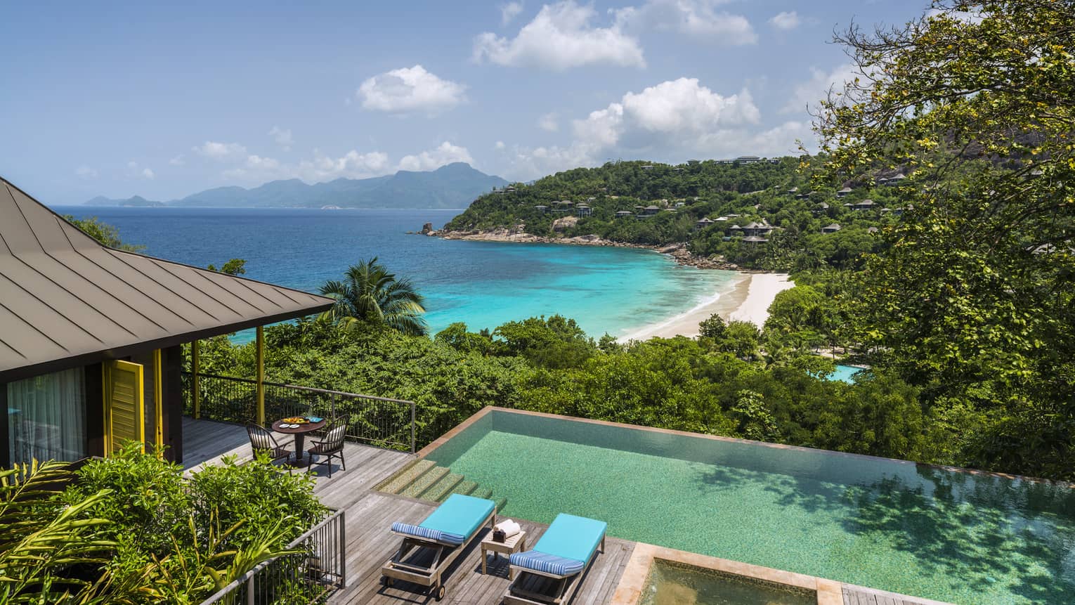 Aerial view of Two-Bedroom Ocean-View Suite pool, chairs and deck, mountain and ocean views
