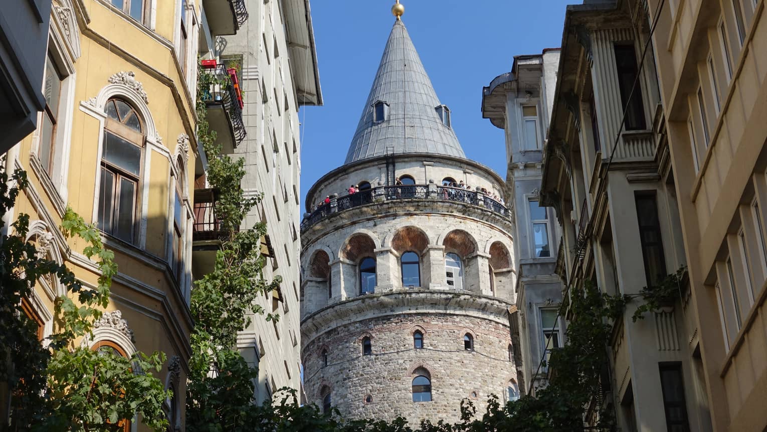 Galata Tower rising up between other buildings