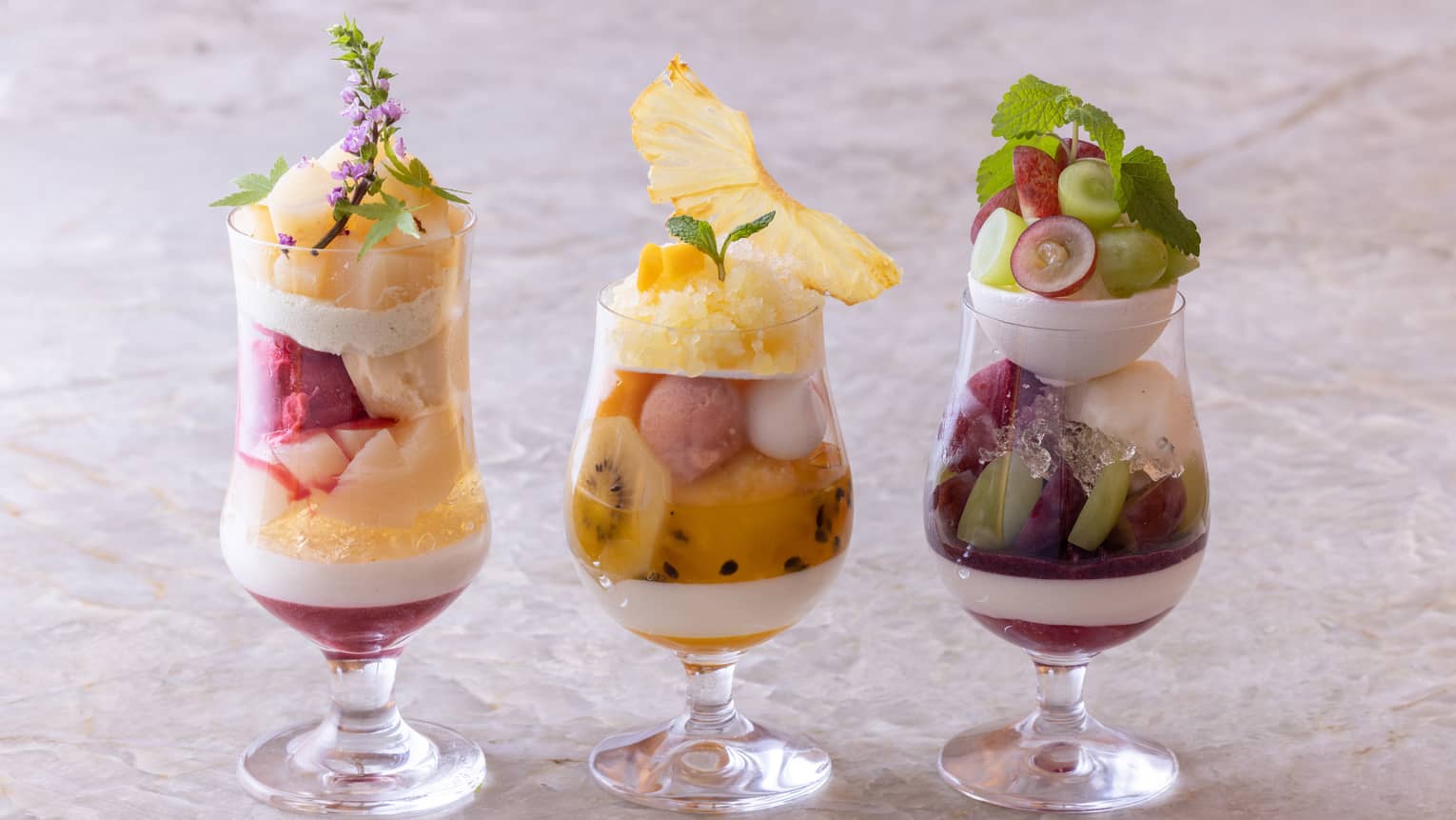 Trio of summer parfaits in stemmed glassware
