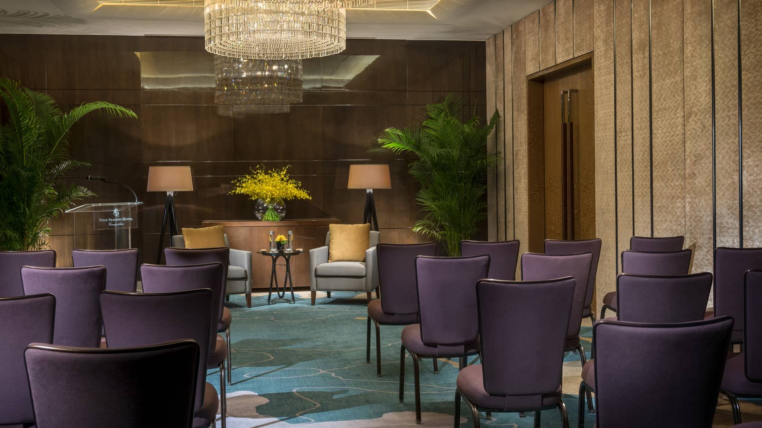 Sapphire Meeting Room conference, rows of purple chairs facing two armchairs