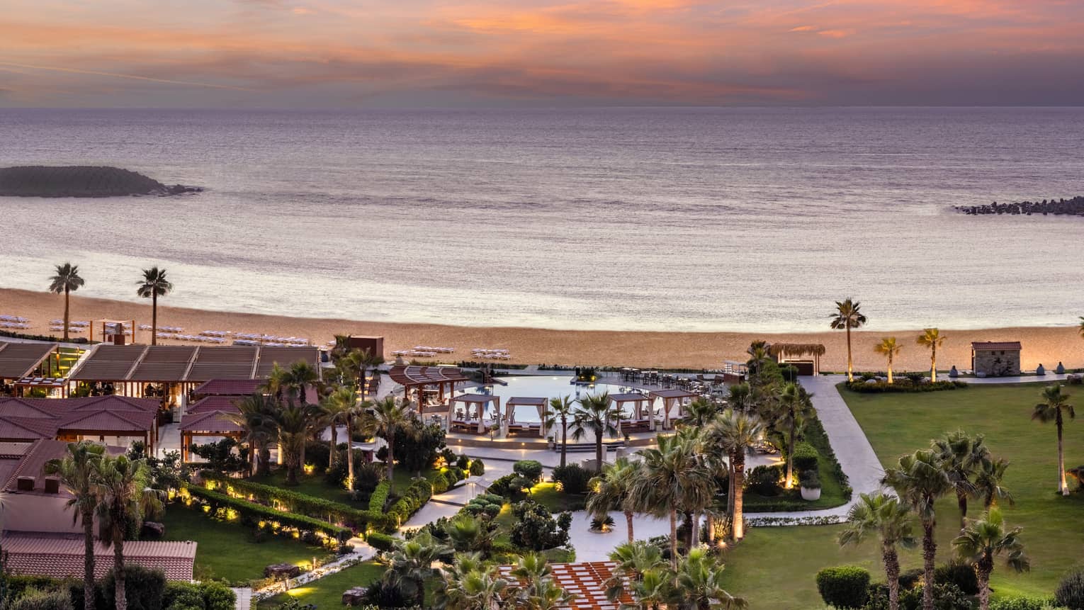 Aerial shot of pool and grounds leading to the beach from the Hotel