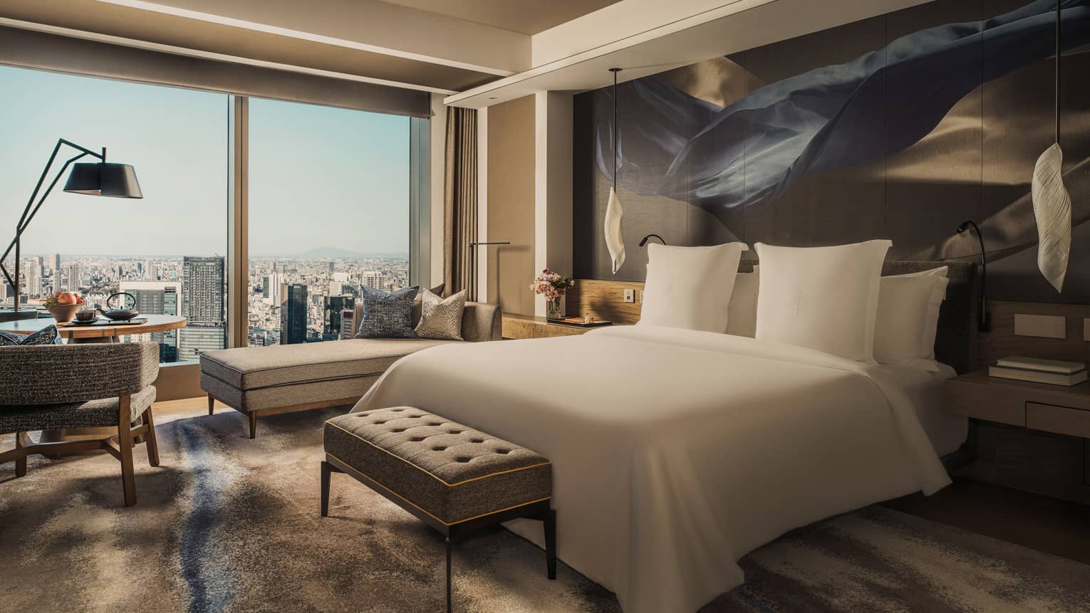 Luxury hotel guest room with king bed and city view