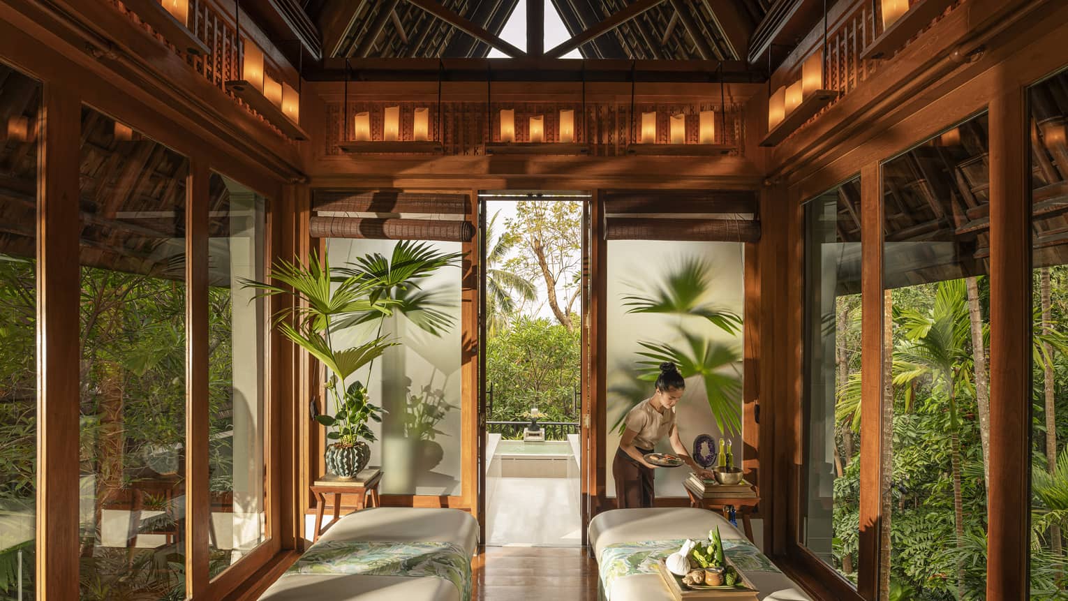 Spa team member prepares couples treatment room