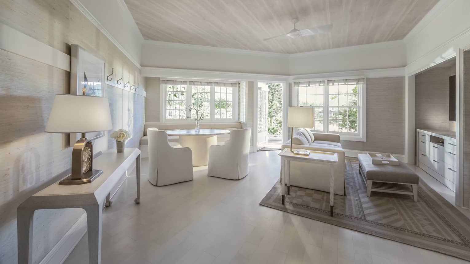 Guest room with white couches and dining table