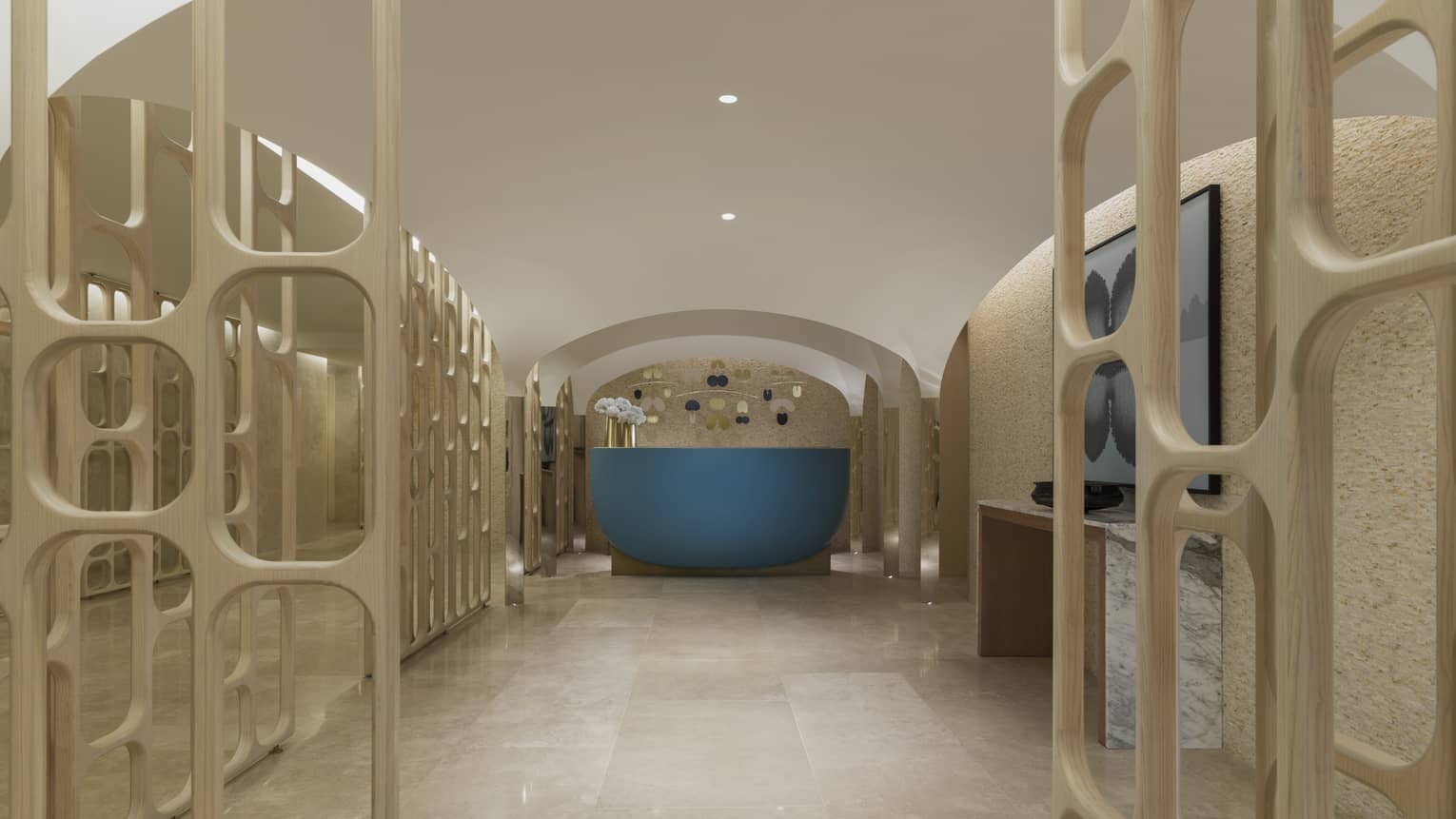 The spa entrance is marked by a blue desk sits on a marble floor