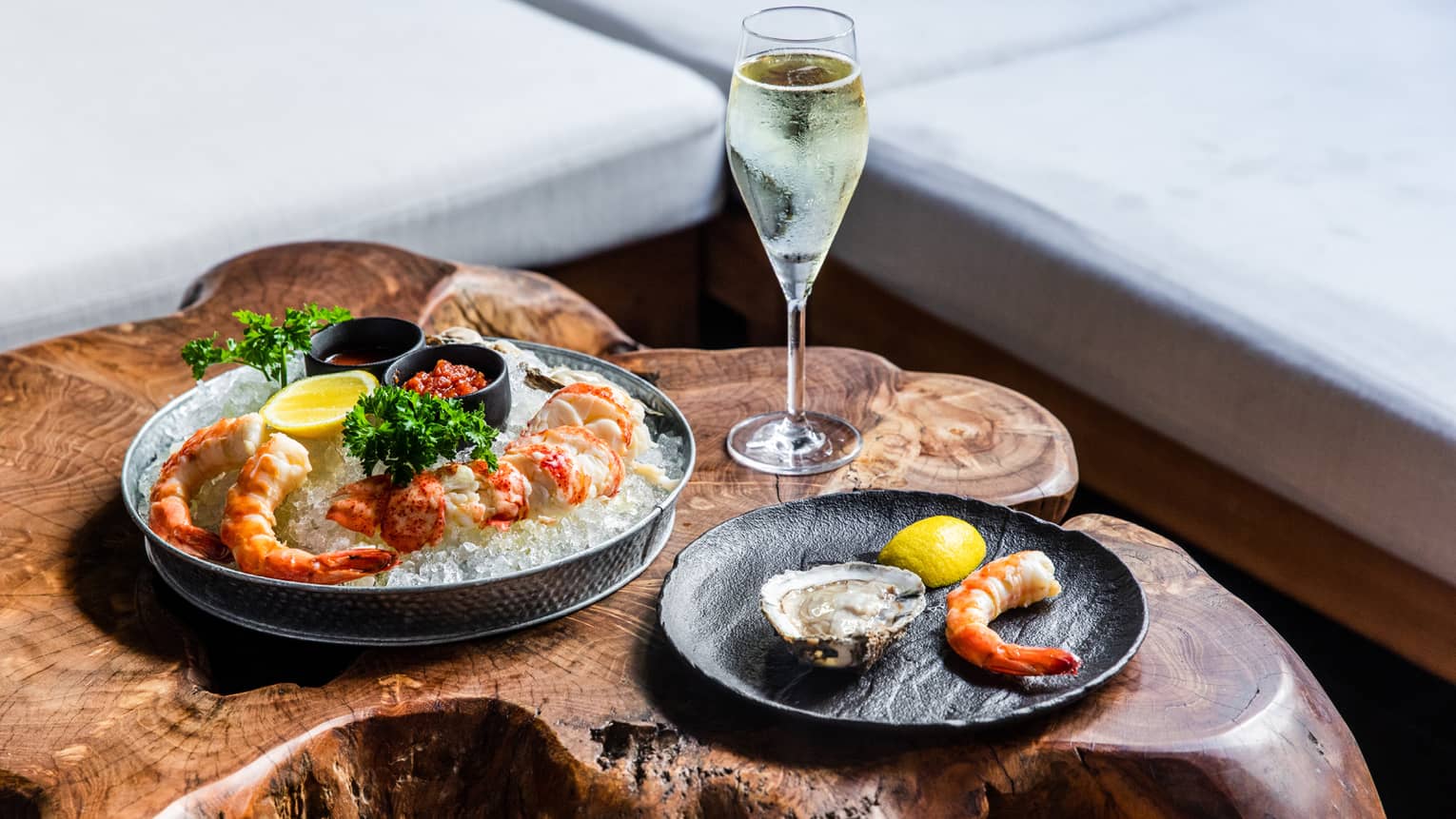 An assortment of seafood and a glass of wine.