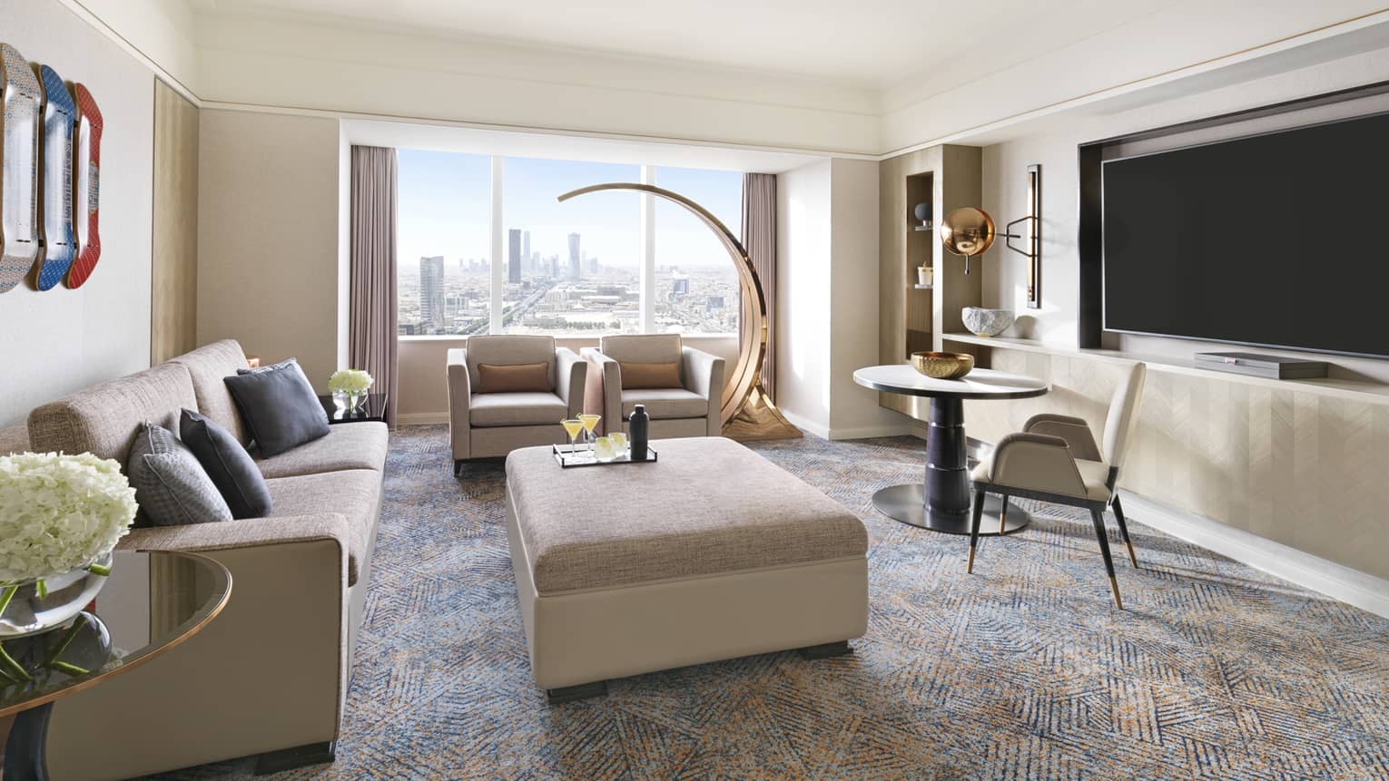 Living room with window, two sofas, matching ottoman/table and TV
