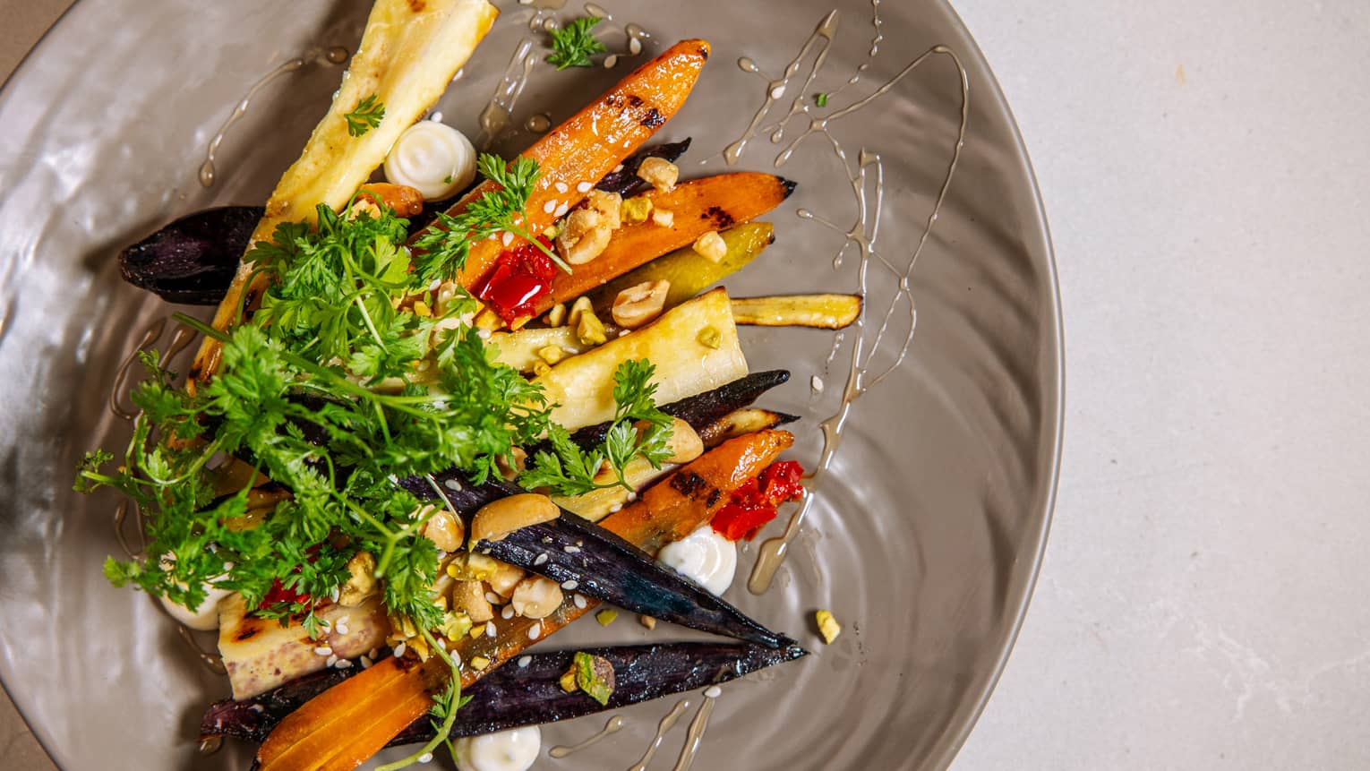A salad of carrots on a grey plate.