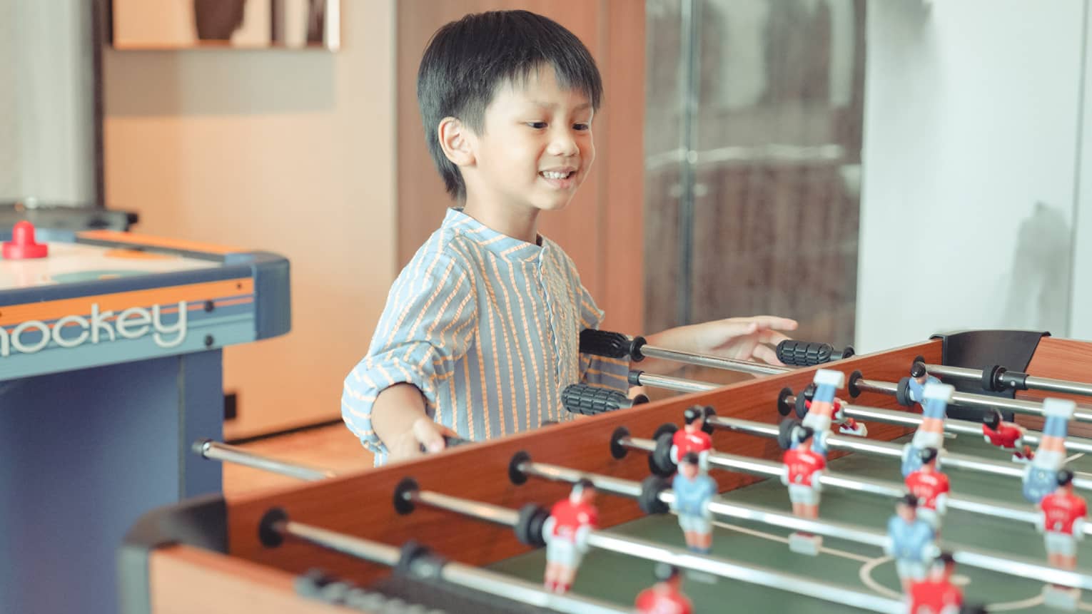 Young boy plays foosball