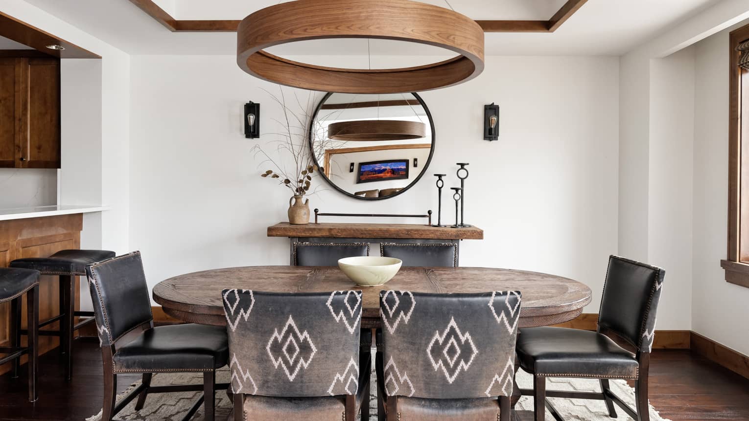 Dining room with wooden table and six leather chairs