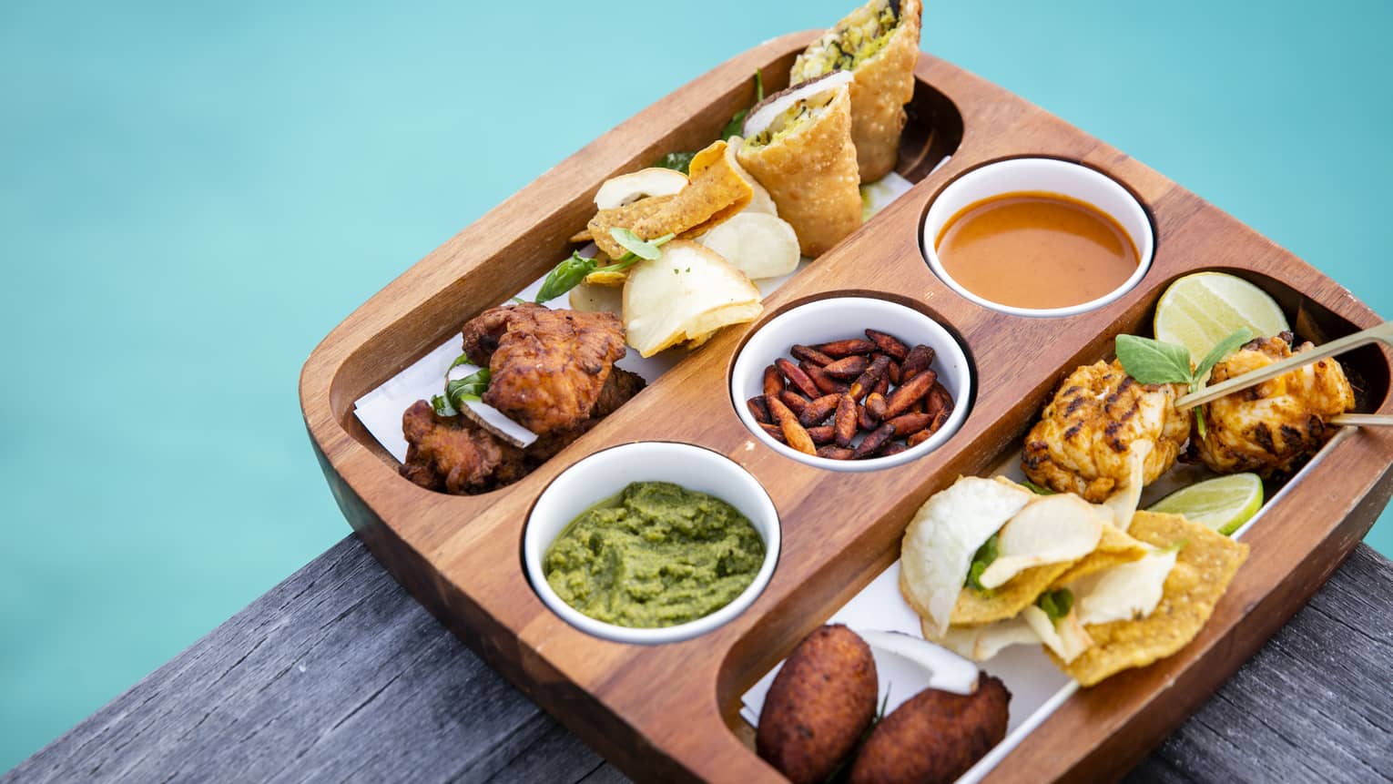 A bamboo tray of an assortment of finger food from the Sunset Bar