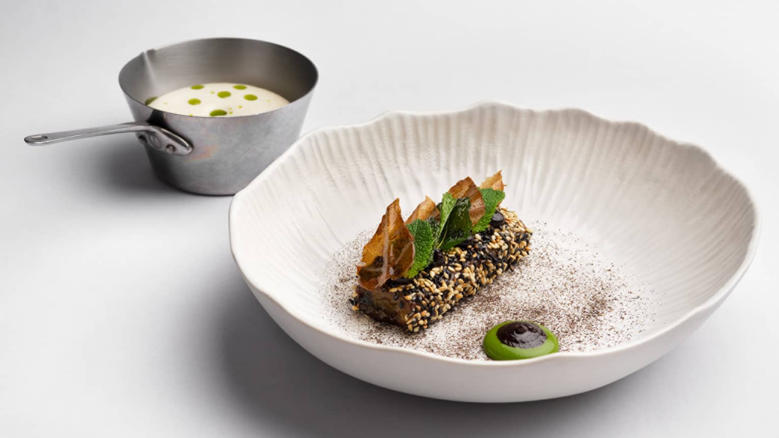 Aubergine with mint and miso in a white bowl.