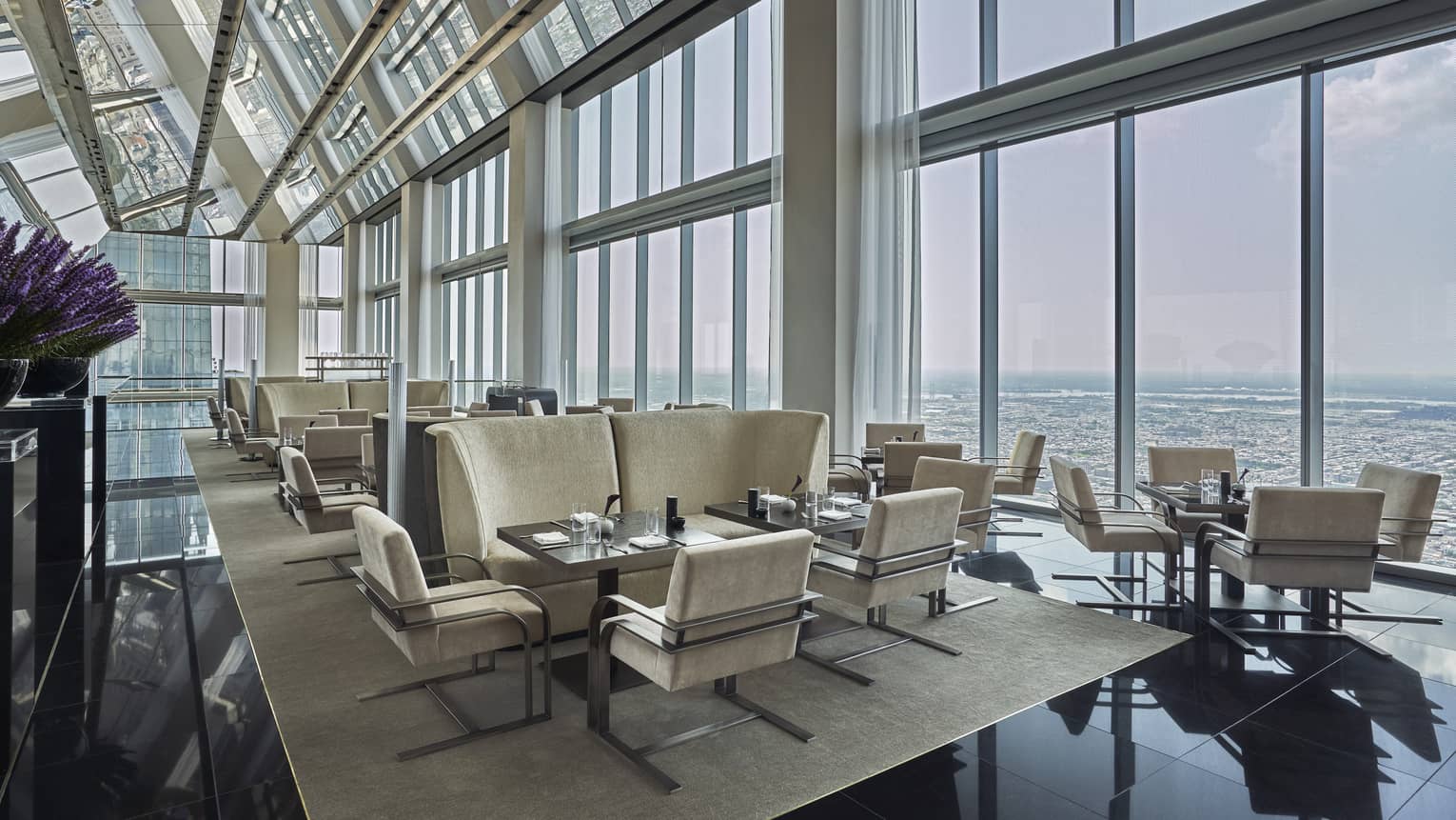 A well lit lounge area in the Skyhigh Lounge overlooking the cityscape. 