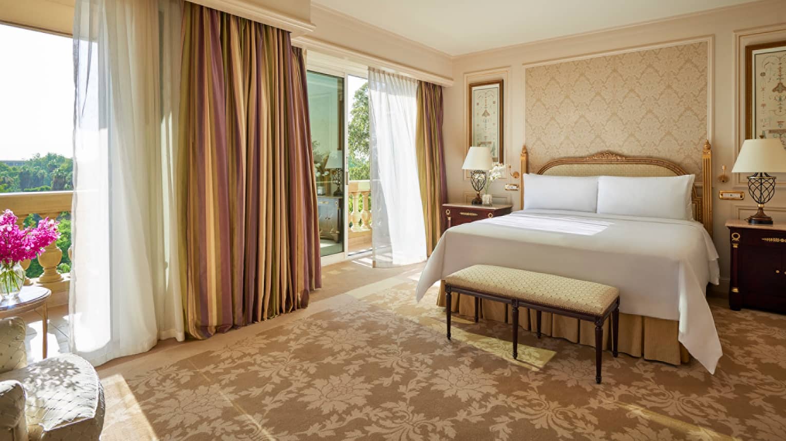 Premium Suite bed, bench near open balcony doors with long curtains