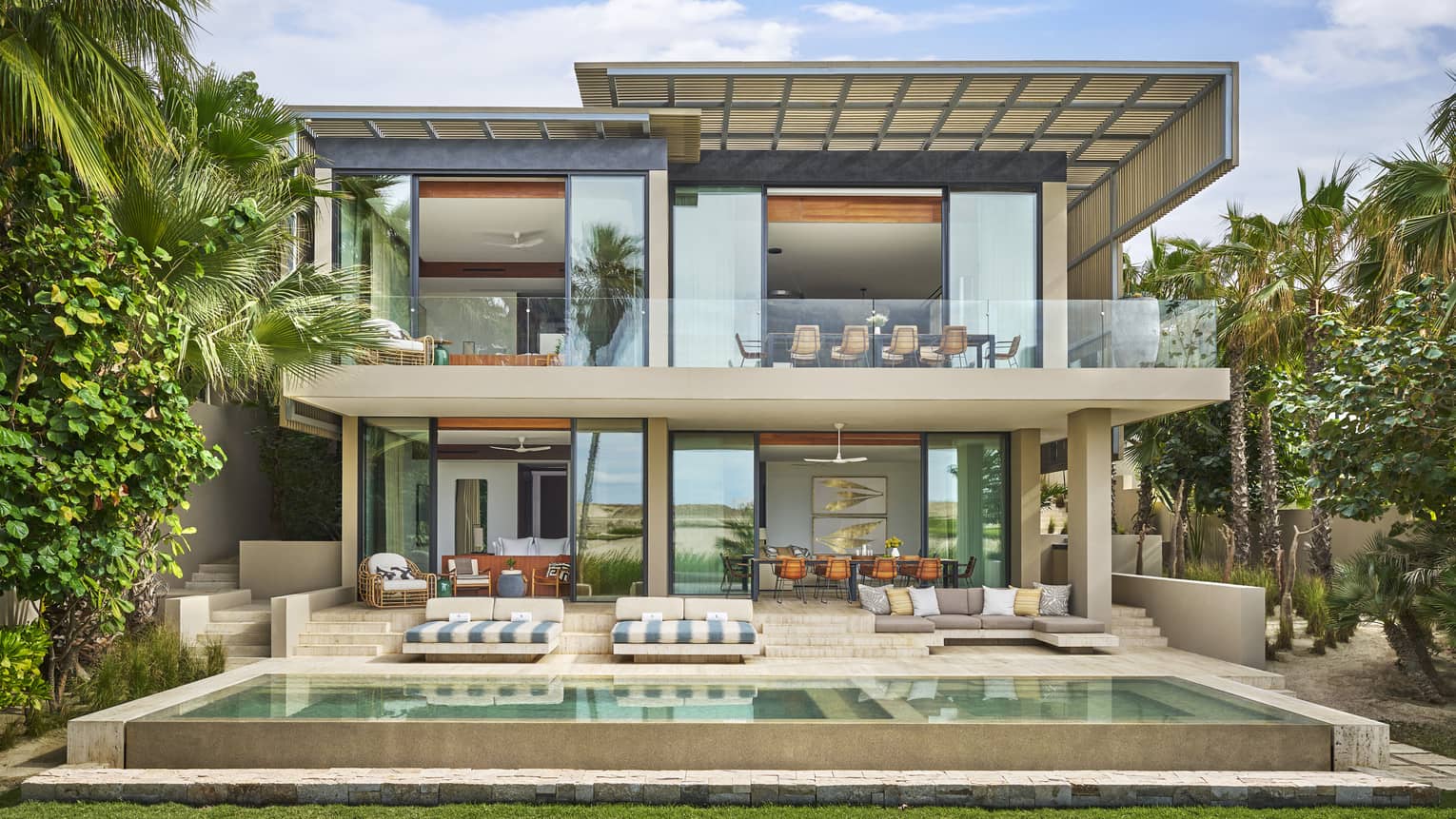 Exterior of the contemporary two-storey luxury Five-Bedroom Oasis Villa with tall windows and private pool