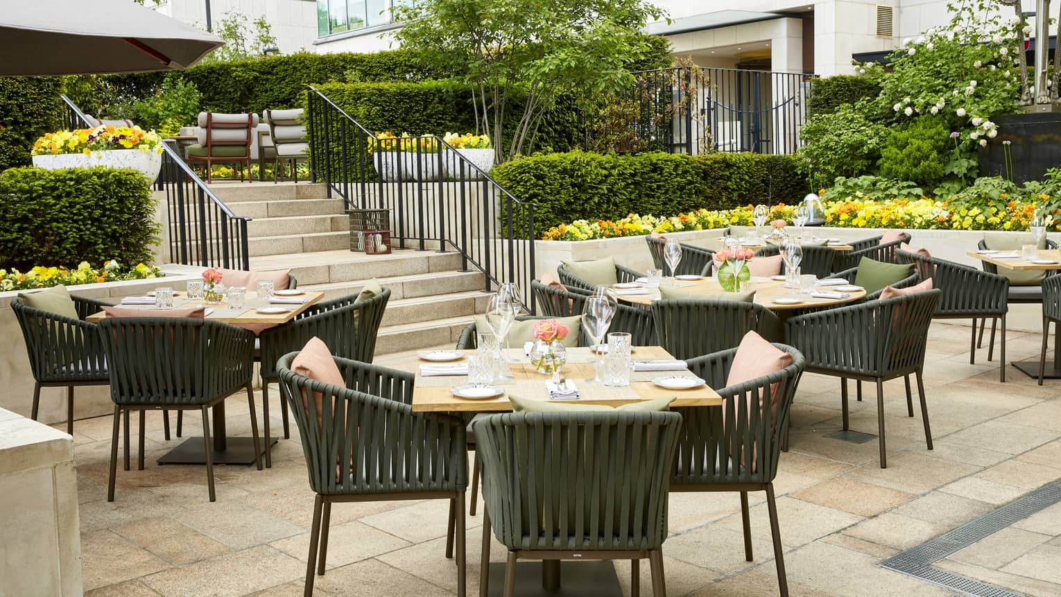 Round dining tables and chairs in Tower Terrace garden patio