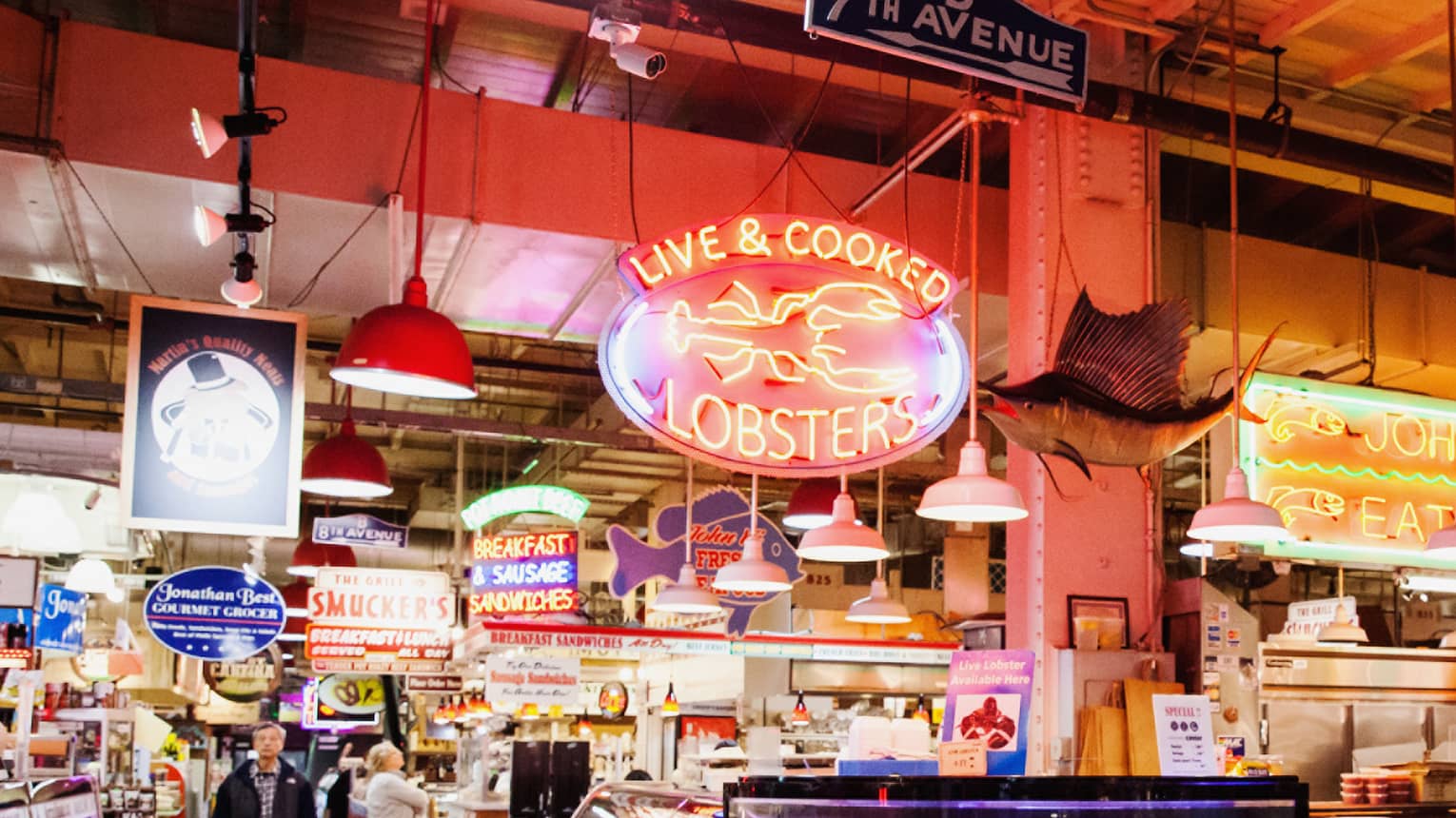 A large indoor market featuring fresh seafood behind glass windows.