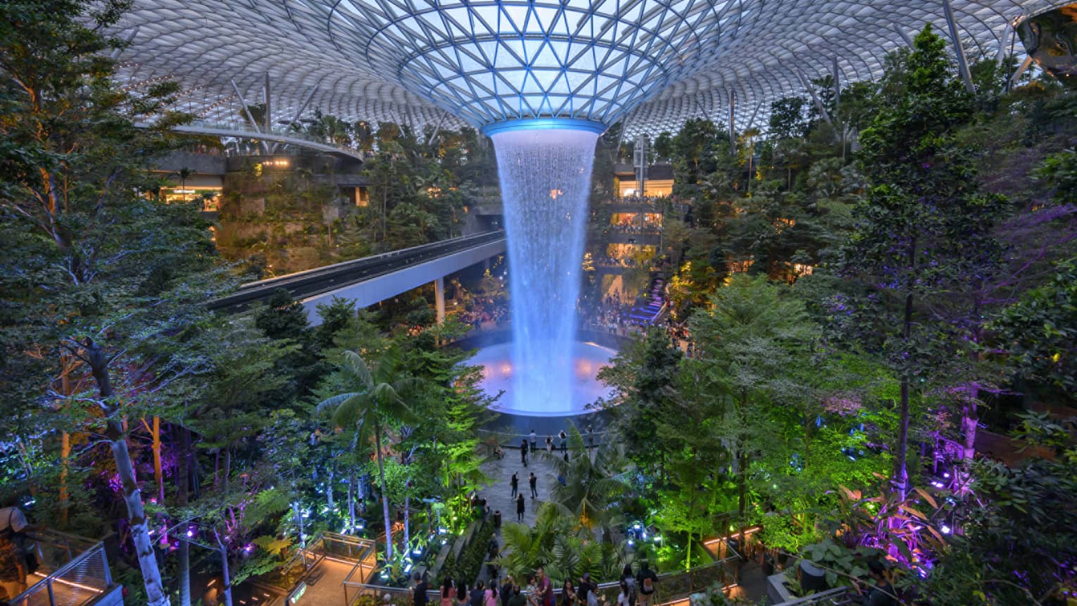 An arial view of an indoor garden with a large fountain in the center in singapore