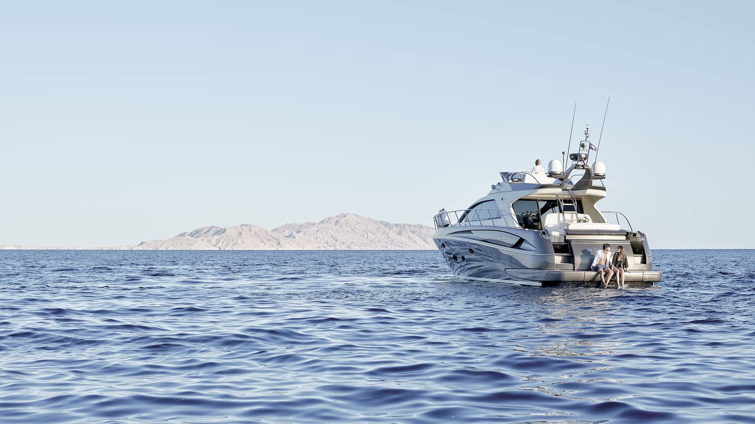 A couple on a luxury boat trip in the middle of the sea