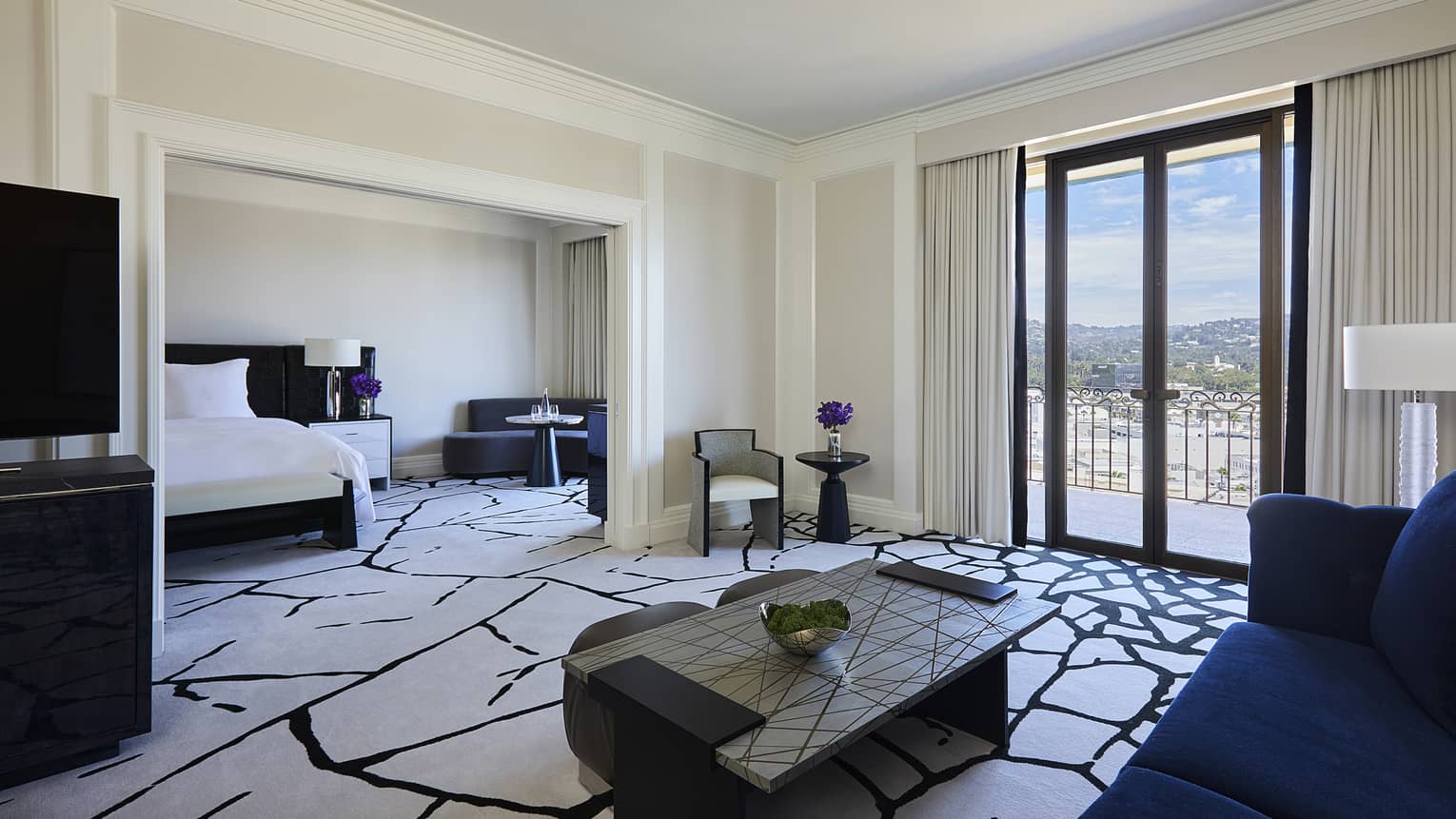 Hotel suite living room opening to bedroom